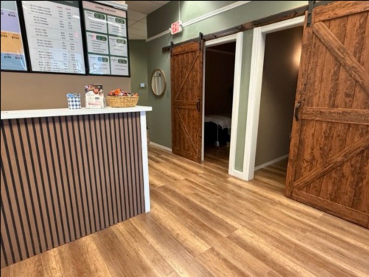 Reception desk and barn doors to massage rooms