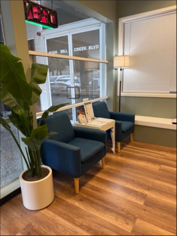 Waiting area with blue armchairs by the window